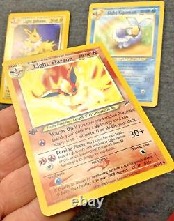 Cartes Pokémon 1ère Édition Ensemble de 3 : Jolteon Lumière, Flareon Lumière, Vaporeon Lumière