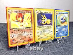 Cartes Pokémon 1ère Édition Ensemble de 3 : Jolteon Lumière, Flareon Lumière, Vaporeon Lumière