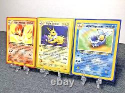 Cartes Pokémon 1ère Édition Ensemble de 3 : Jolteon Lumière, Flareon Lumière, Vaporeon Lumière